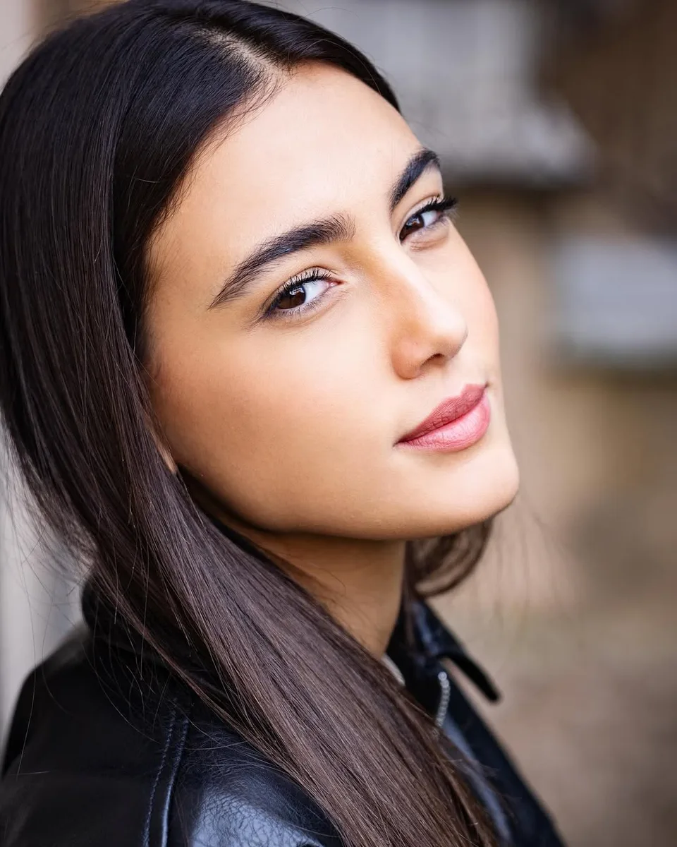 A close portrait of Zeudi turning toward the camera with her hair over one shoulder.